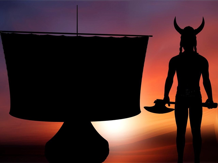 Silhouette of traditional viking ship and viking warrior with ax at sunset